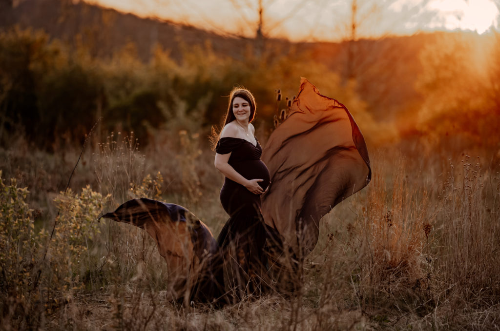 Gown toss in sunset maternity outdoors