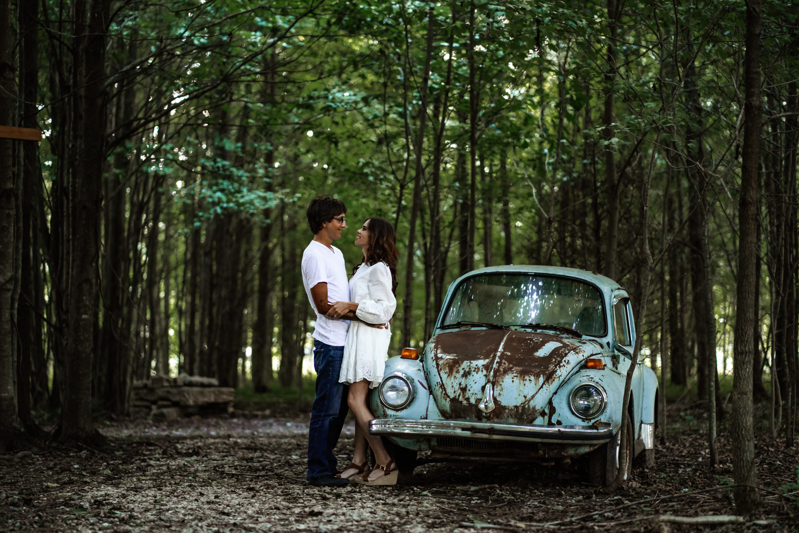 engagement session in woods with vintage VW Bug