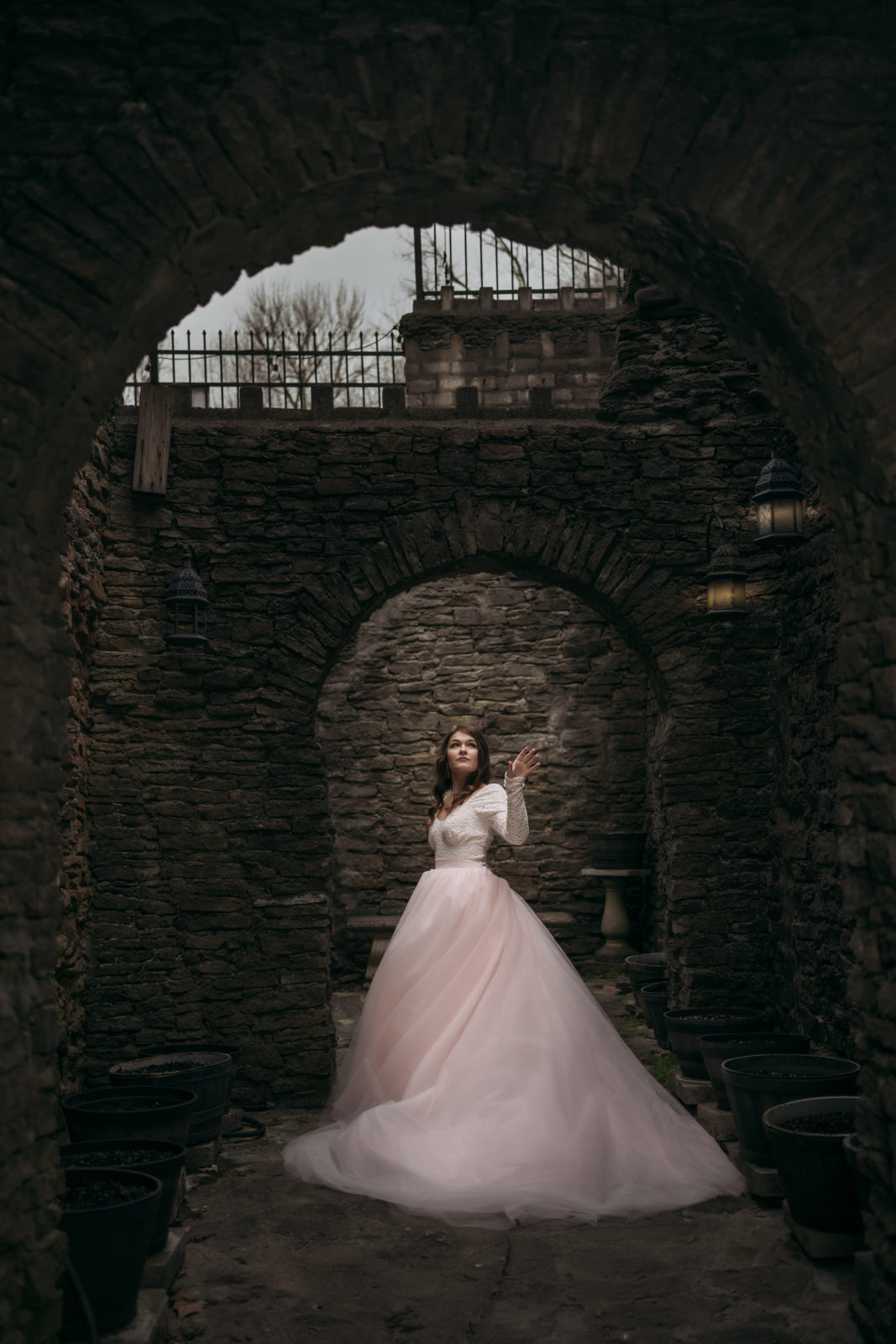 Loveland Castle Senior Session. White lace top with light pink tulle full length skirt. Dramatic lighting with glowing lanterns. 