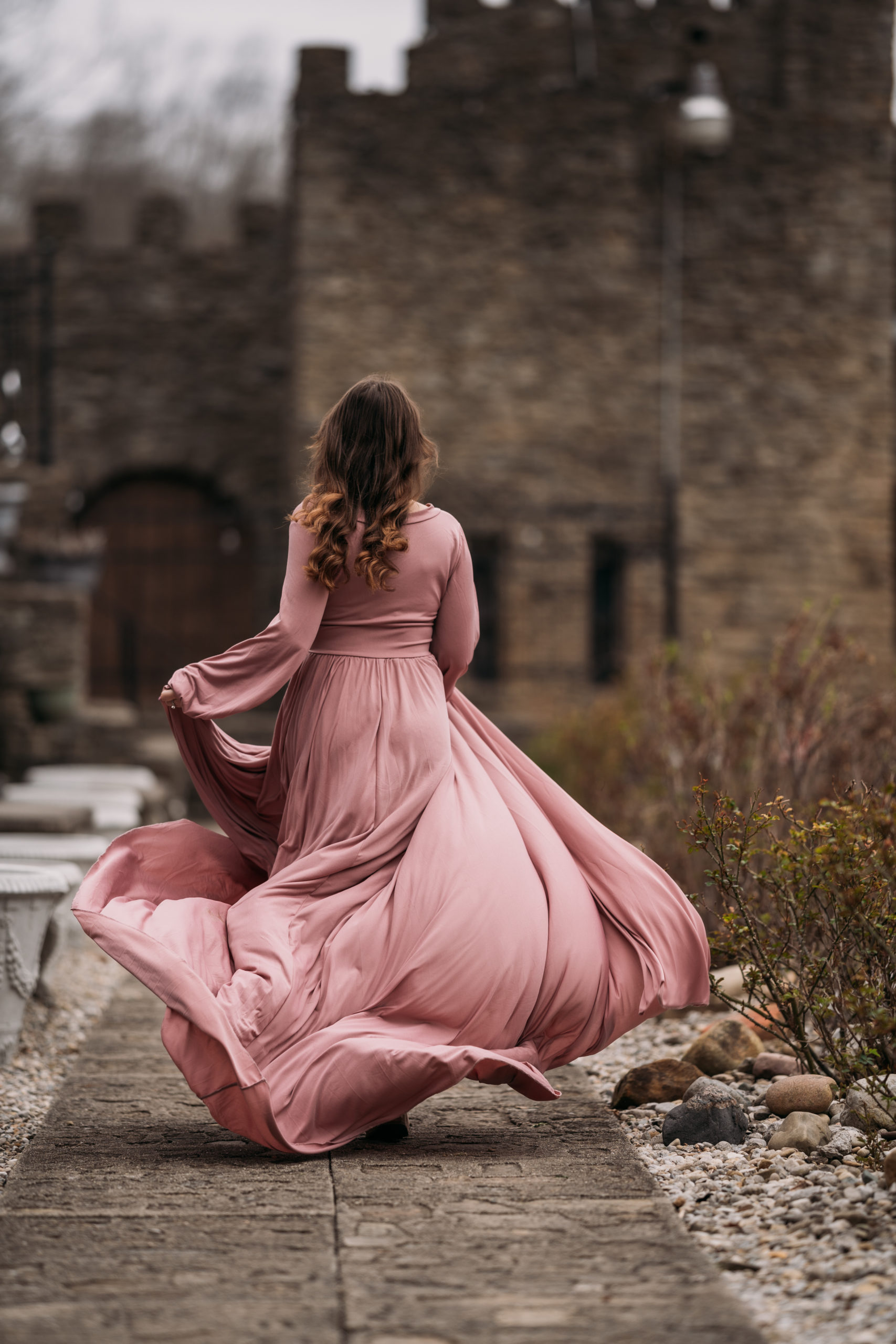 Loveland Castle Senior Session. Flowy dusty rose gown in the gardens. Dramatic fairytale run down the path