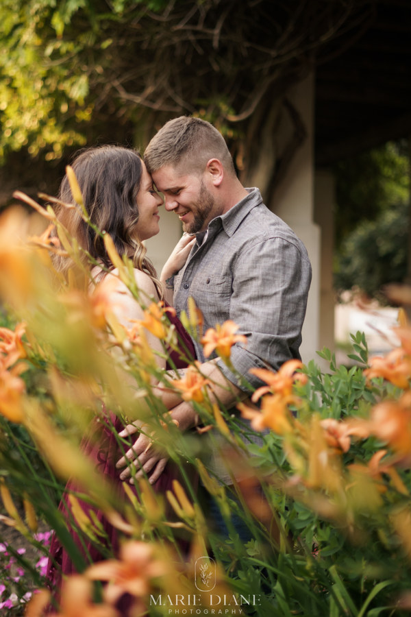 engagement session with flowers in foreground 